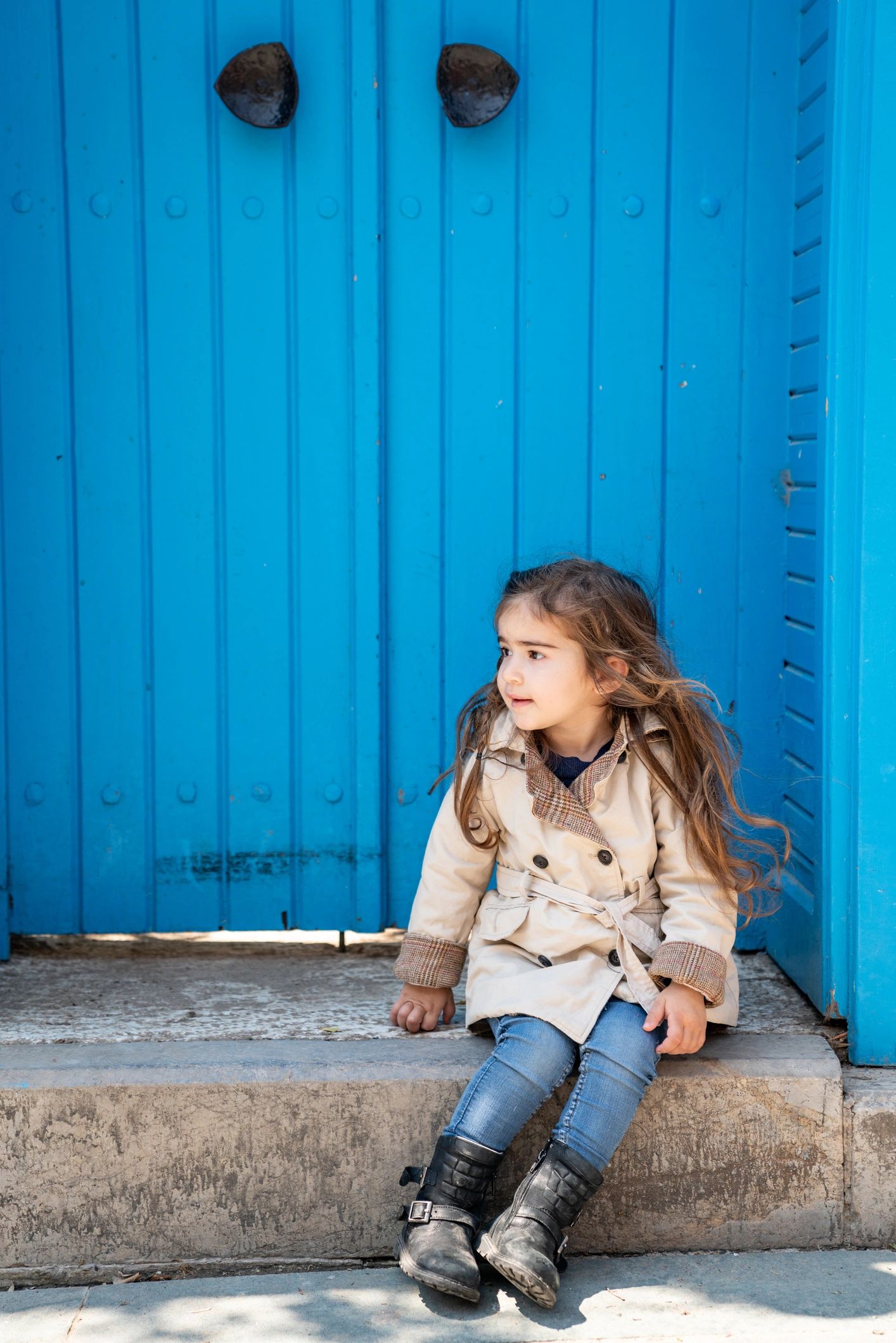 Child in a beige designer coat