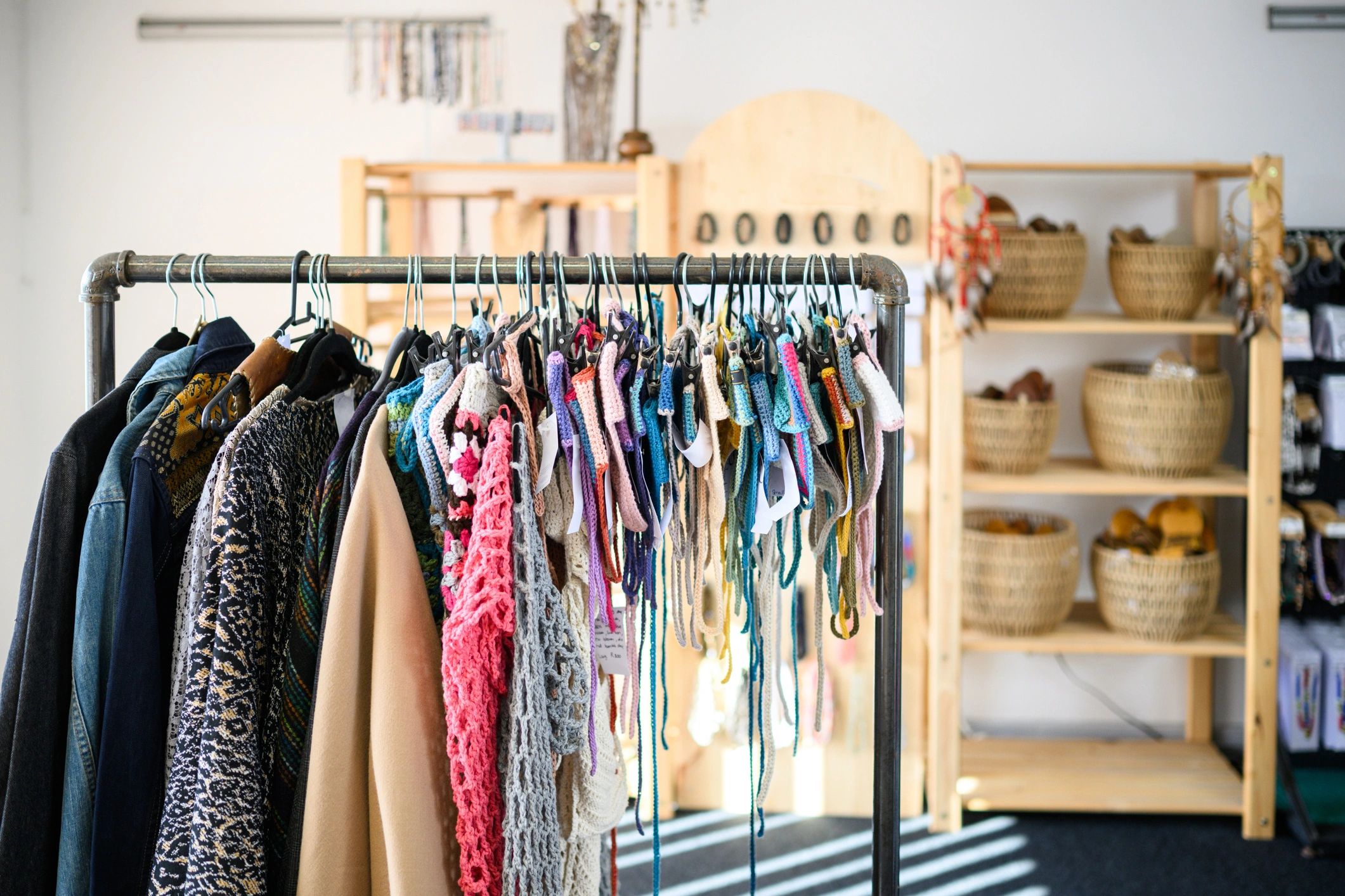 Colourful garments on a boutique clothing rack